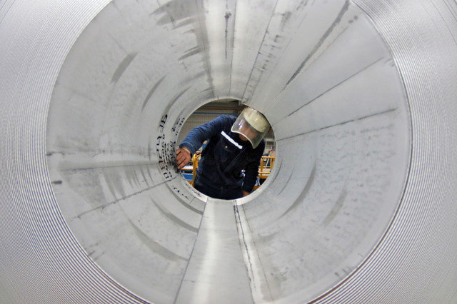 An employee works on the production line of aluminum rolls at a factory in Zouping, Shandong province, China, on November 23, 2019. Picture taken November 23, 2019. REUTERS/Stringer