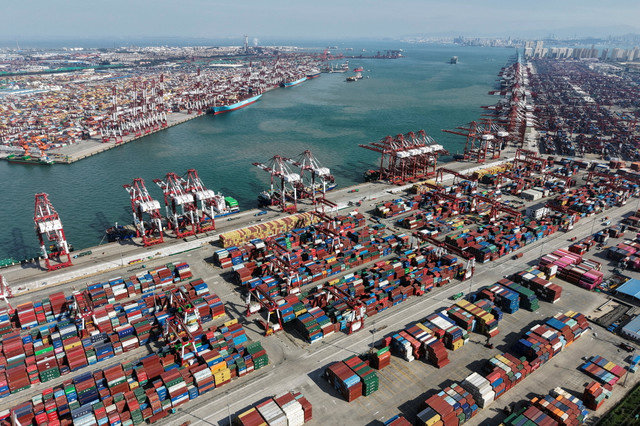 A drone view captures ships and containers at the port in Qingdao, Shandong province, China, on October 20, 2025. China Daily via REUTERS