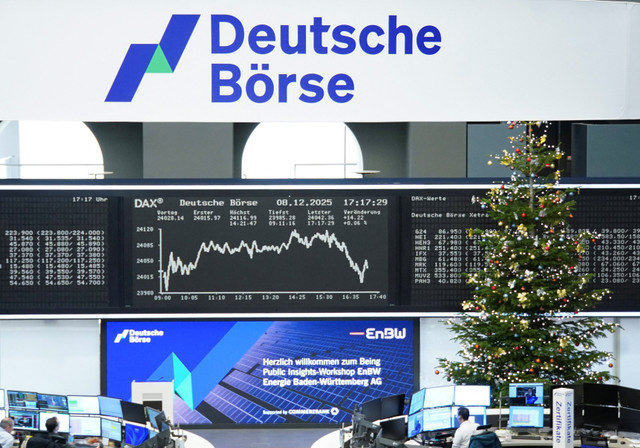 A Christmas Tree stands next to the German share price index DAX graph at the stock exchange in Frankfurt, Germany, December 8, 2025. REUTERS/staff