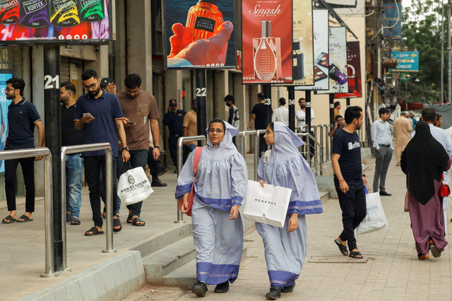 People walk outside a shopping mall in Karachi, Pakistan on September 23, 2025. REUTERS/Akhtar Soomro