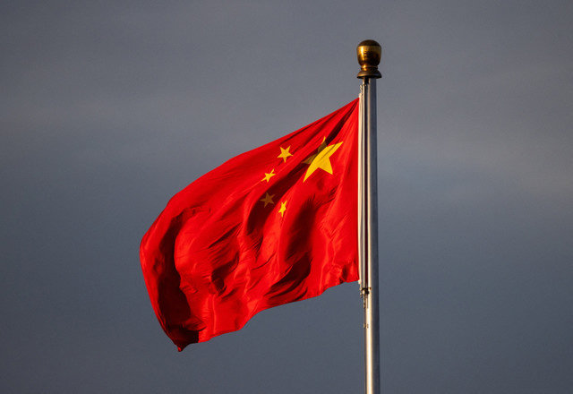 China’s national flag flutters in the wind, illuminated by the sunrise in Beijing, China, on November 20, 2025. REUTERS/Maxim Shemetov