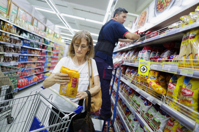 A customer examines a product at a wholesaler in Buenos Aires, Argentina, on December 11, 2025. REUTERS/Francisco Loureiro