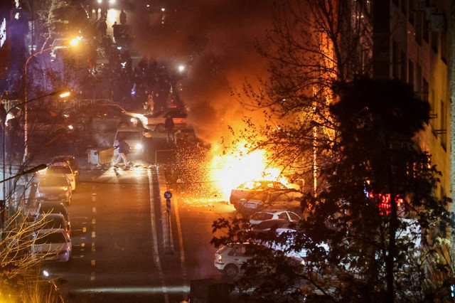 Cars burn in a street during a protest over the collapse of the currency's value, in Tehran, Iran, January 8, 2026. Stringer/WANA (West Asia News Agency) via REUTERS