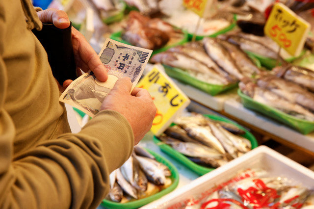 Một người đàn ông mua cá tại một khu chợ ở Tokyo, Nhật Bản, ngày 3 tháng 3 năm 2023. REUTERS/Androniki Christodoulou