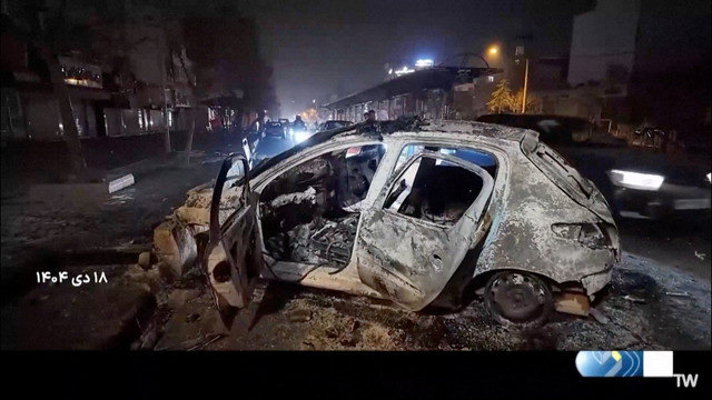 A burnt car lies on the road following unrest sparked by dire economic conditions in Tehran, Iran, January 10, 2026, in this screengrab from state media broadcast footage. IRIB via WANA(West Asia News Agency) via REUTERS