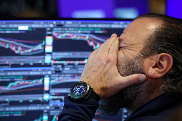 A trader works on the floor at the New York Stock Exchange (NYSE) in New York City, U.S., January 15, 2026. REUTERS/Brendan McDermid