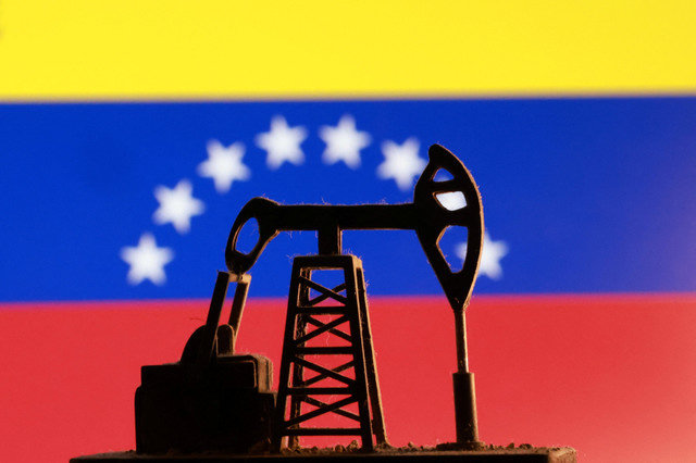A model of an oil pump is seen in front of a Venezuelan flag in this illustration taken January 9, 2026. REUTERS/Dado Ruvic/Illustration