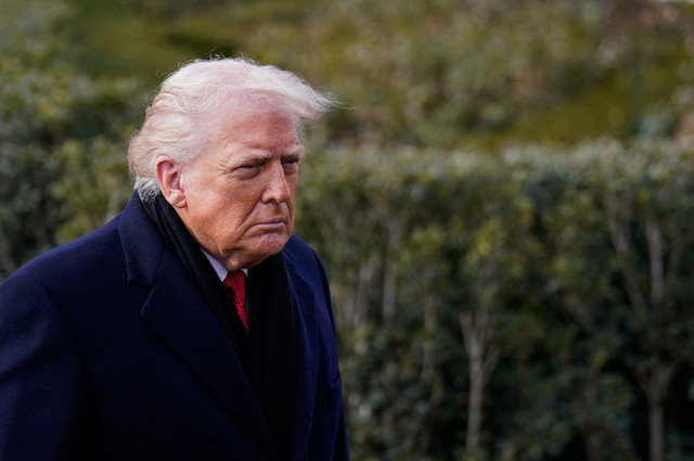 U.S. President Donald Trump looks on before departing for Florida from the South Lawn of the White House in Washington, D.C., U.S., January 16, 2026. REUTERS/Nathan Howard