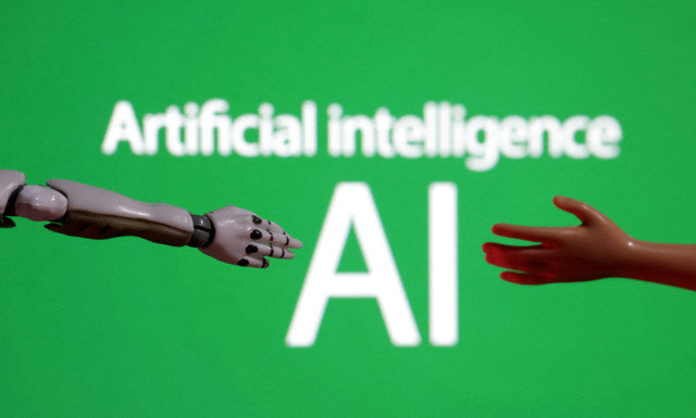 The words "Artificial intelligence AI", alongside a miniature robot and a toy hand, are depicted in this illustration taken on December 14, 2023. REUTERS/Dado Ruvic/Illustration