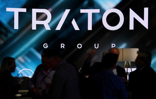 FILE PHOTO: Visitors stand at the booth of Volkswagen's truck unit Traton Group, former Volkswagen Truck & Bus AG, in Hanover, Germany September 19, 2018. REUTERS/Fabian Bimmer/File Photo