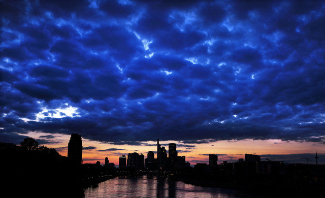 The sun sets behind the skyline in Frankfurt, Germany, September 15, 2024. REUTERS/Kai Pfaffenbach