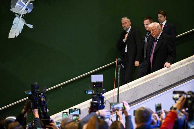 U.S. President Donald Trump walks during the 56th annual World Economic Forum (WEF) meeting in Davos, Switzerland, January 22, 2026. REUTERS/Romina Amato