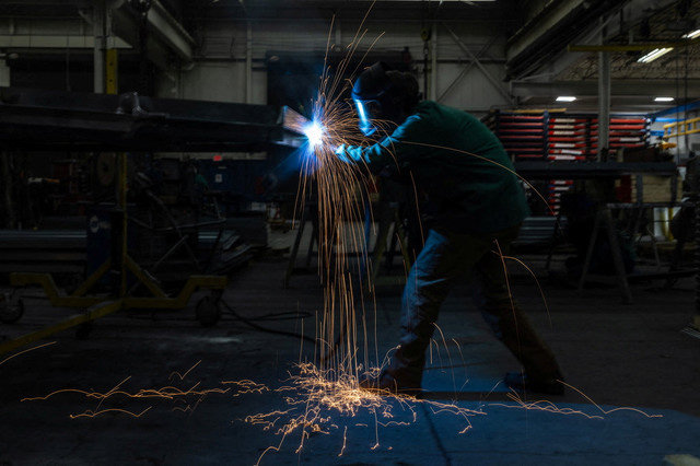 A worker welds on the factory floor in Columbus, Ohio, U.S., March 26, 2024. REUTERS/Carlos Barria