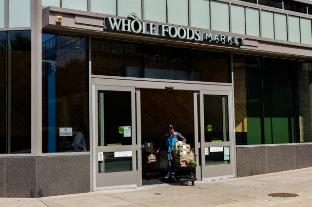 พนักงานของ Amazon เข็นรถเข็นสินค้าออกจาก Whole Foods Market ในเมืองฟิลาเดลเฟีย รัฐเพนซิลเวเนีย สหรัฐอเมริกา เมื่อวันที่ 3 กันยายน 2025 REUTERS/Hannah Beier