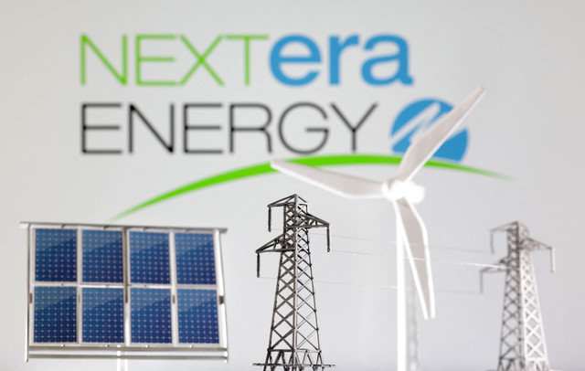 Miniatures of a windmill, solar panel, and electric pole are shown in front of the NextEra Energy logo in this illustration taken January 17, 2023. REUTERS/Dado Ruvic/Illustration