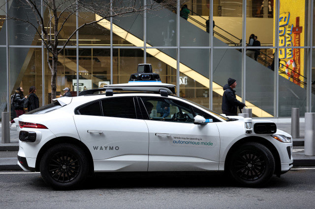 FILE PHOTO: A Waymo driverless taxi parks in lower Manhattan in New York City, U.S., November 26, 2025. REUTERS/Brendan McDermid/File Photo
