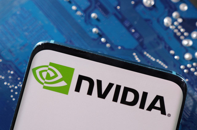 A smartphone displaying the NVIDIA logo is placed on a computer motherboard in this illustration taken March 6, 2023. REUTERS/Dado Ruvic/Illustration