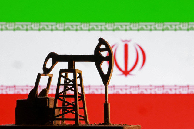 A model of an oil pump is seen in front of an Iranian flag in this illustration taken January 9, 2026. REUTERS/Dado Ruvic/Illustration