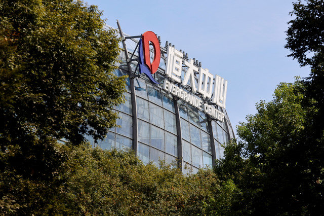 The logo of the China Evergrande Group is seen on the Evergrande Center in Shanghai, China, September 24, 2021. REUTERS/Aly Song