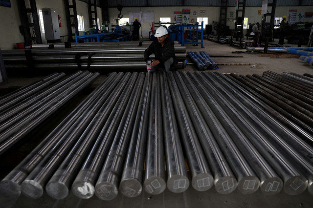 FILE PHOTO: A worker checks the density of steel bars inside a steel factory on the outskirts of Ahmedabad, India, January 28, 2026. REUTERS/Amit Dave/File Photo