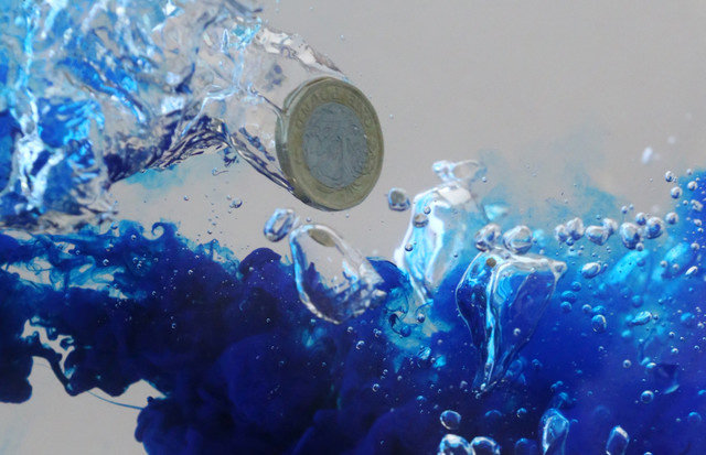An illustration picture shows a UK pound coin plunging into water on October 26, 2017. REUTERS/Dado Ruvic