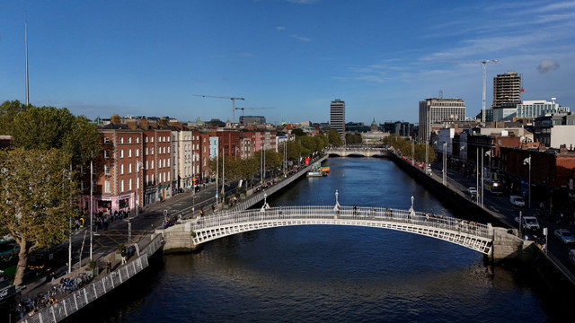 A drone view shows people walking over the Ha'penny Bridge on the river Liffey with the Spire visible, in the city centre of Dublin, Ireland October 7, 2024. REUTERS/Clodagh Kilcoyne/File Photo