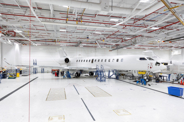 Mọi người đứng cạnh một chiếc máy bay Bombardier Global 7500 tại trung tâm hoàn thiện máy bay phản lực tư nhân của Bombardier ở Montreal, Quebec, Canada vào ngày 6 tháng 2 năm 2025. REUTERS/Evan Buhler/File Photo/File Photo