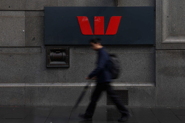 A man passes a logo displayed outside a Westpac Banking Corp. branch in Sydney, Australia, August 19, 2025. REUTERS/Hollie Adams