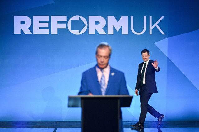 Robert Jenrick walks onto the stage as Britain's Reform UK leader Nigel Farage announces him as the party's Shadow Chancellor of the Exchequer in London, Britain, February 17, 2026. REUTERS/Chris J. Ratcliffe
