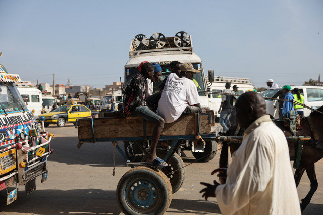 Men sit on a horse-drawn cart in Thiaroye on the outskirts of Dakar, Senegal, March 10, 2024. REUTERS/ Zohra Bensemra