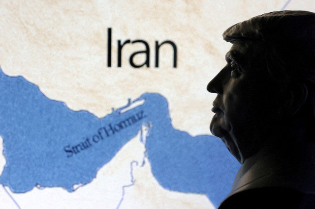 A map showing the Strait of Hormuz and Iran is seen behind a 3D printed miniature of U.S. President Donald Trump in this illustration taken June 22, 2025. REUTERS/Dado Ruvic/Illustration/File Photo
