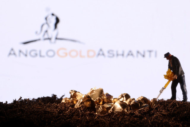 A small toy figure and gold imitation are seen in front of the AngloGold Ashanti logo in this illustration taken November 19, 2021. REUTERS/Dado Ruvic/Illustration