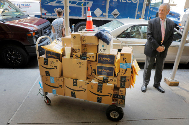FILE PHOTO: A delivery cart loaded with Amazon packages stands on a sidewalk in New York City, New York, U.S., on July 25, 2019. REUTERS/Lucas Jackson/File Photo