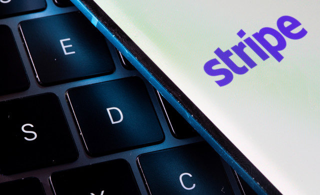 A smartphone with the Stripe logo is placed on a laptop in this illustration taken on July 14, 2021. REUTERS/Dado Ruvic/Illustration
