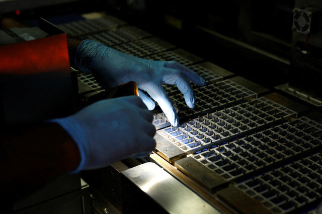 FOTO DE ARCHIVO: Un técnico inspecciona la maquinaria con una linterna en un centro de fabricación de paneles solares en Greater Noida, a las afueras de Nueva Delhi, India, el 23 de octubre de 2024. REUTERS/Priyanshu Singh/File Photo