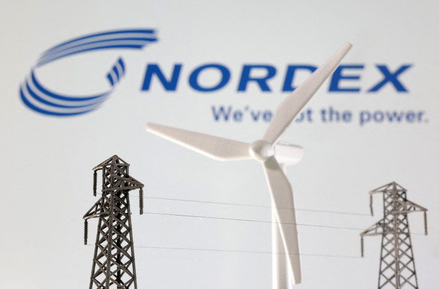 Miniatures of a windmill and an electric pole are seen in front of the Nordex logo in this illustration taken January 17, 2023. REUTERS/Dado Ruvic/Illustration