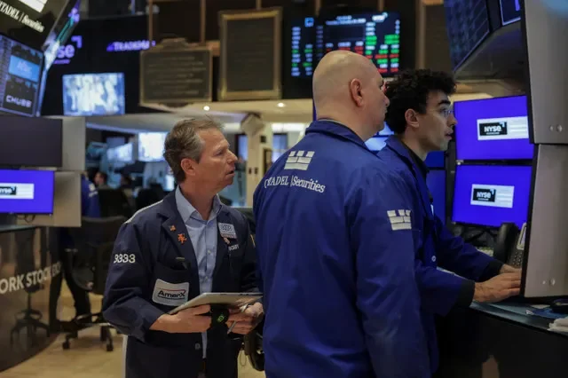 Traders work on the floor at the New York Stock Exchange (NYSE) in New York City, U.S. February 24, 2026. REUTERS/Jeenah Moon