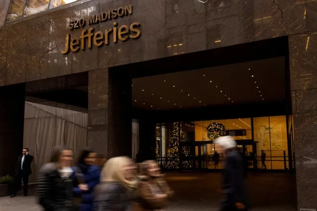 Pedestrians walk outside the Jefferies Financial Group offices in Manhattan, New York, on December 8, 2021. REUTERS/Eduardo Munoz