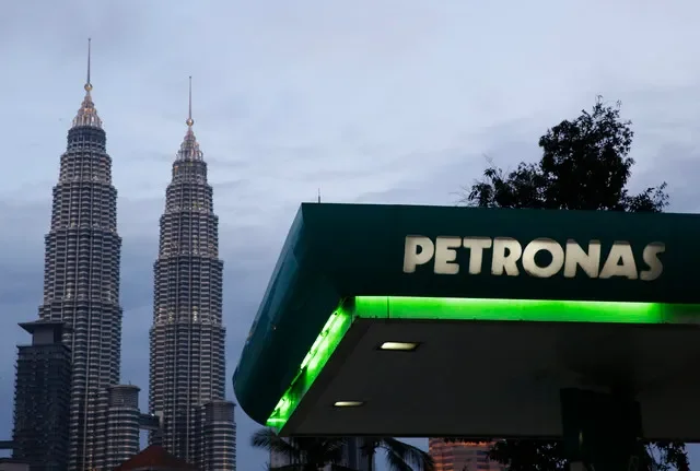 A view of a Petronas service station in Kuala Lumpur with the iconic Petronas Twin Towers rising in the distance, captured in February 2016. REUTERS/Olivia Harris
