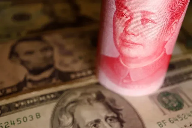 A collection of U.S. Dollar and Chinese Yuan banknotes displayed in an illustrative photo from June 2022. REUTERS/Florence Lo/Illustration