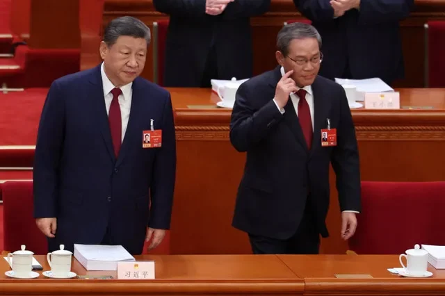 Chinese President Xi Jinping and Chinese Premier Li Qiang look on during the opening session of the National People's Congress (NPC) at the Great Hall of the People in Beijing, China, March 5, 2026. REUTERS/Florence Lo/Pool