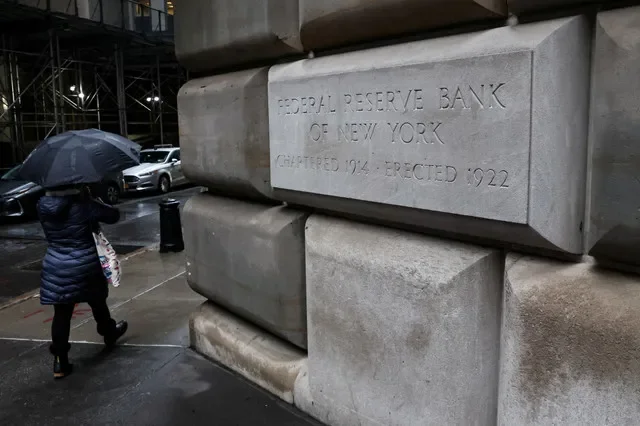 A pedestrian walks past the Federal Reserve Bank of New York building in Manhattan, captured in March 2023. REUTERS/Brendan McDermid/File Photo
