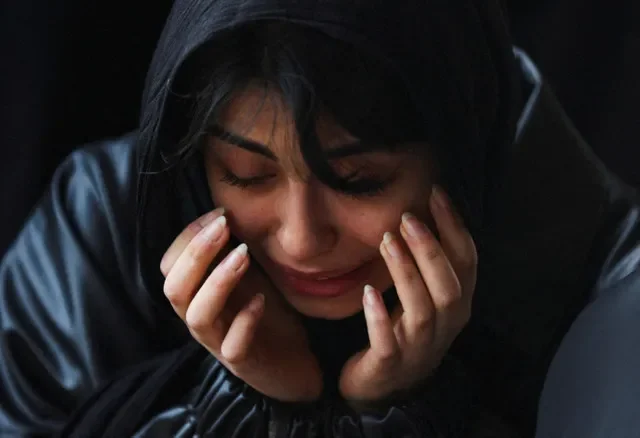 A woman expresses her sorrow during a memorial service in Tehran for individuals lost in the current wave of airstrikes. Majid Asgaripour/WANA via REUTERS