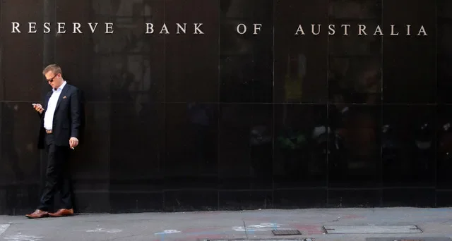 An individual stands near the Reserve Bank of Australia's headquarters in Sydney's central business district in February 2018. REUTERS/Daniel Munoz