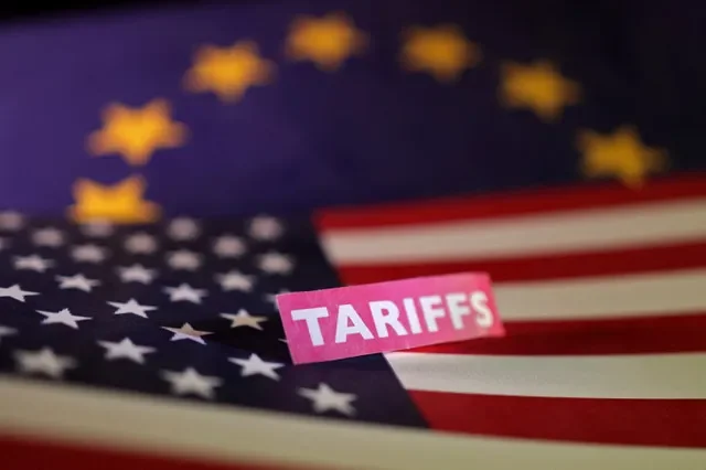 An illustration from April 2025 depicts the flags of the United States and the European Union next to a label for tariffs. REUTERS/Dado Ruvic/Illustration