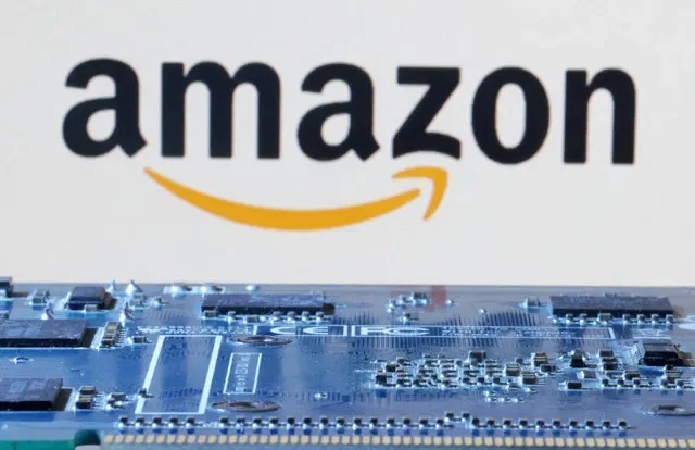 An Amazon logo is positioned next to a computer circuit board in this January 2024 illustration. REUTERS/Dado Ruvic/Illustration/File Photo