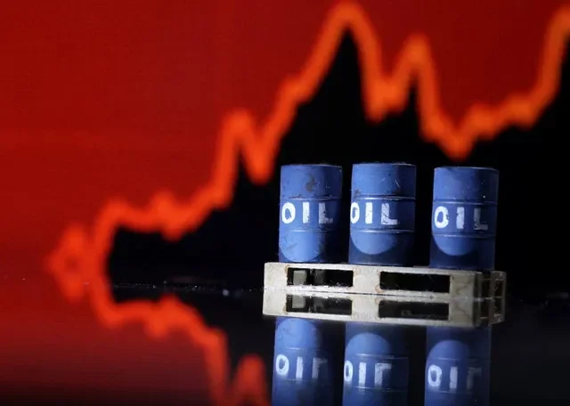 A representation of oil barrels positioned before a rising stock market graph illustrates the current energy price surge. REUTERS/Dado Ruvic/Illustration
