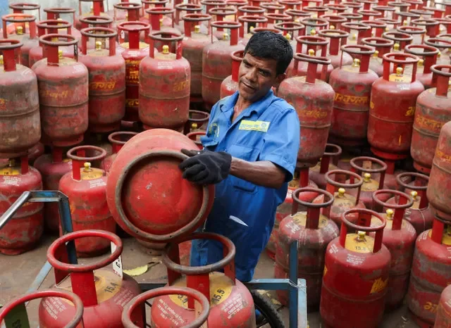 A worker transports LPG cylinders at a Mumbai warehouse as supply chains are disrupted by the U.S.-Israeli conflict with Iran, March 11, 2026. REUTERS/Francis Mascarenhas