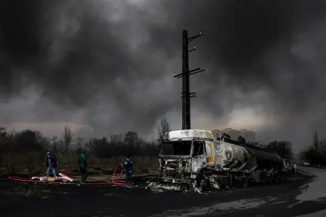 Smoke billows from destroyed vehicles following a strike on fuel storage tanks in Tehran during the ongoing regional conflict. Majid Asgaripour/WANA via REUTERS