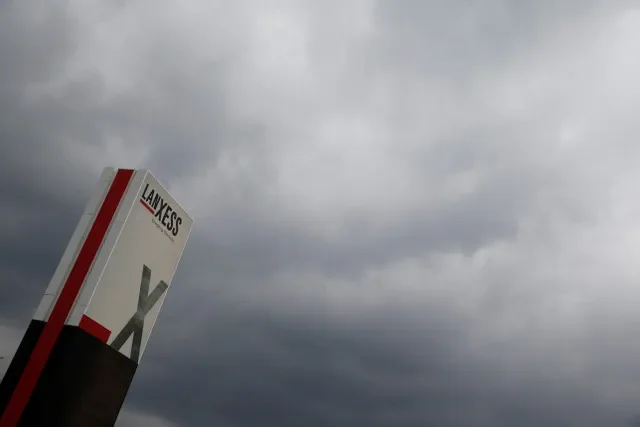 The Lanxess company logo is pictured next to dark clouds at the Cologne Bonn airport in this file photo from March 2015. REUTERS/Wolfgang Rattay/File Photo